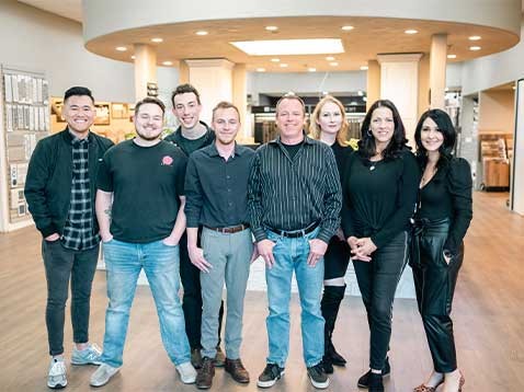 Company staff standing together and smiling inside the store,